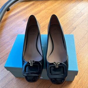 Tory Burch mini square heel patent leather shoes.